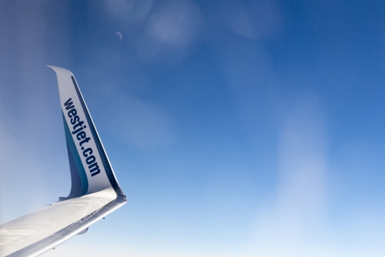 Winglet detail Westjet Boeing 737 Plane Flying Blue Sky